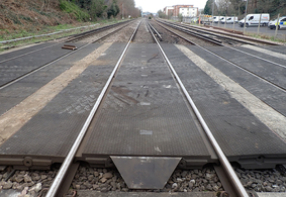 View towards Walton-on-Thames station along the Up Fast line showing the railway access point deck and a broken section of redundant rail